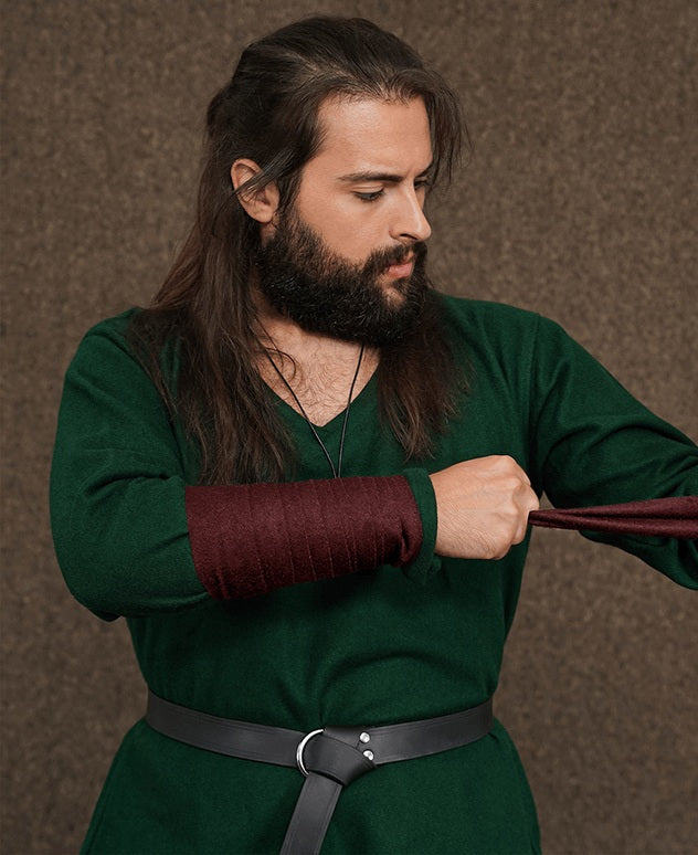 Woolen Arm Wraps with Brooches worn wrapped around the forearm over a green tunic sleeve