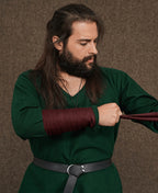 Woolen Arm Wraps with Brooches worn wrapped around the forearm over a green tunic sleeve
