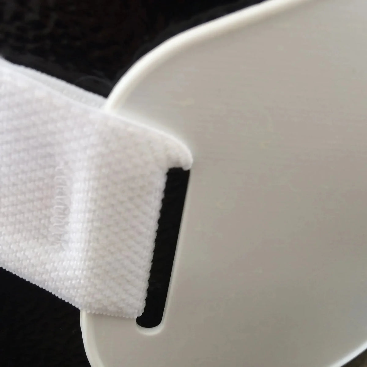 Close up of strap on women's chest protector.