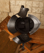 Kaspar Burgonet Helmet in Blackened finish, rear angle on wooden display, neck tail detail