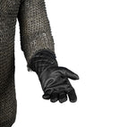 Palm detail of a black leather knight's glove.