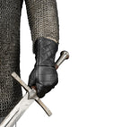 Close up view of an armored man wearing a lightly padded black leather glove.