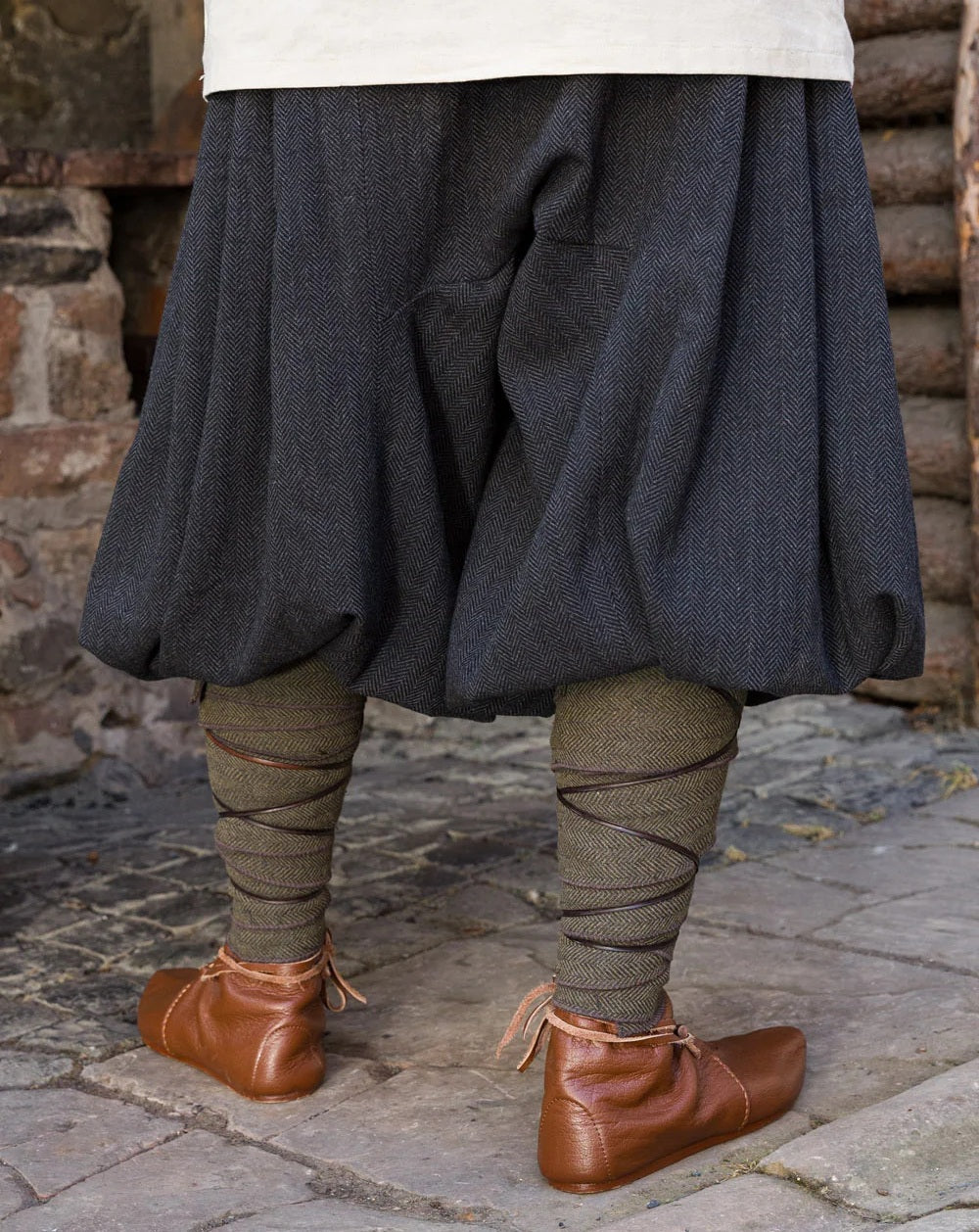 Rear shot of model wearing Borys grey Ren Faire trousers.