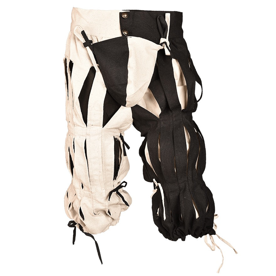 A pair of medieval-style linen hose or leg wraps in black and off-white, featuring straps, buckles, and ties, displayed against a solid white background.