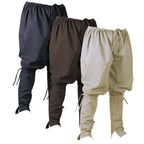 Three pairs of loose-fitting drawstring harem-style pants shown overlapping on a white background, in dark navy, dark brown, and light beige.