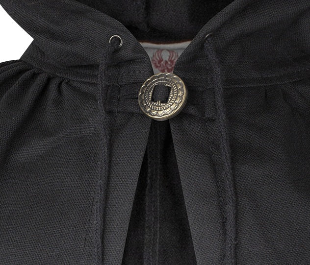 Close-up of a black hooded garment with a large round metallic button closure at the neck.